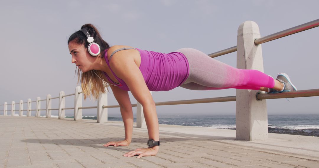 Woman Exercising with Push-Ups Along Seaside Promenade - Free Images, Stock Photos and Pictures on Pikwizard.com