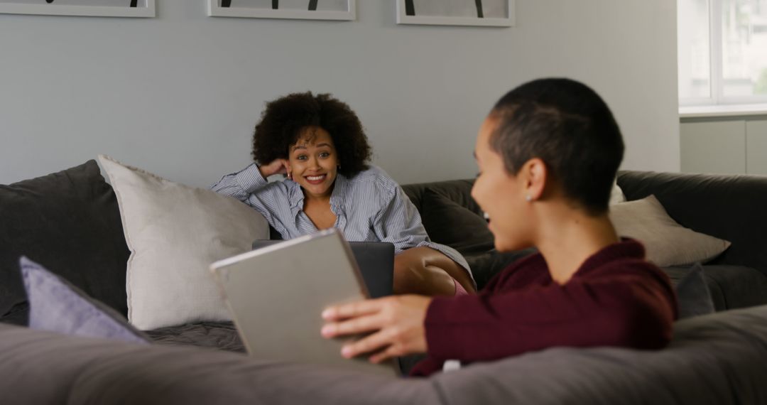 Two Smiling Women Relaxing on Sofa with Tablet at Home - Free Images, Stock Photos and Pictures on Pikwizard.com