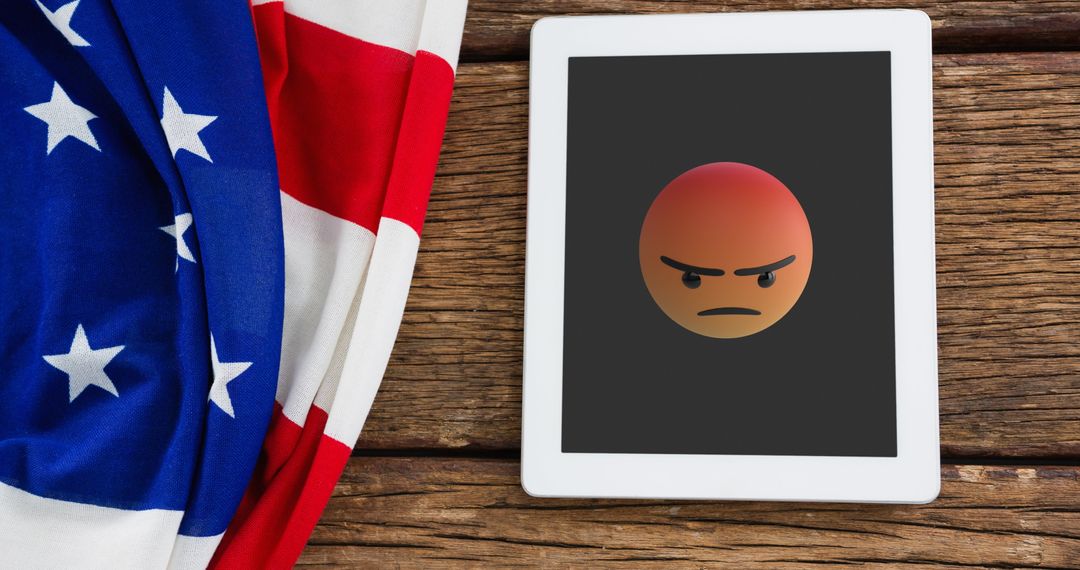 Tablet Displaying Angry Emoji with American Flag and Rustic Wood