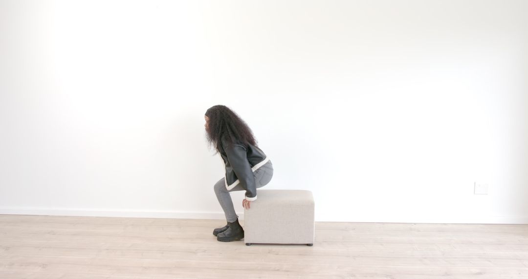 Woman Sitting on Cube Reflecting in Modern Minimalist Room