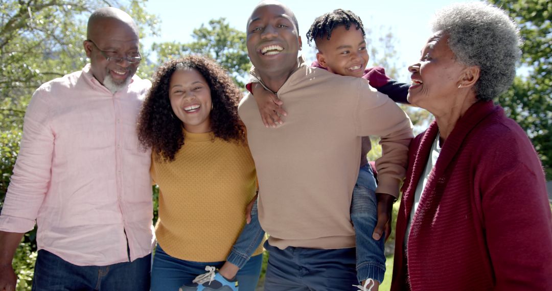 African American Family Laughing Together Outdoors in Sunshine - Free Images, Stock Photos and Pictures on Pikwizard.com