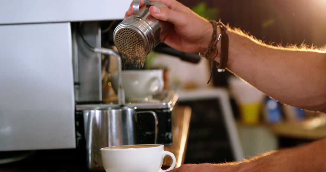 Barista Sprinkling Cocoa Powder on Coffee Cup at Café - Free Images, Stock Photos and Pictures on Pikwizard.com