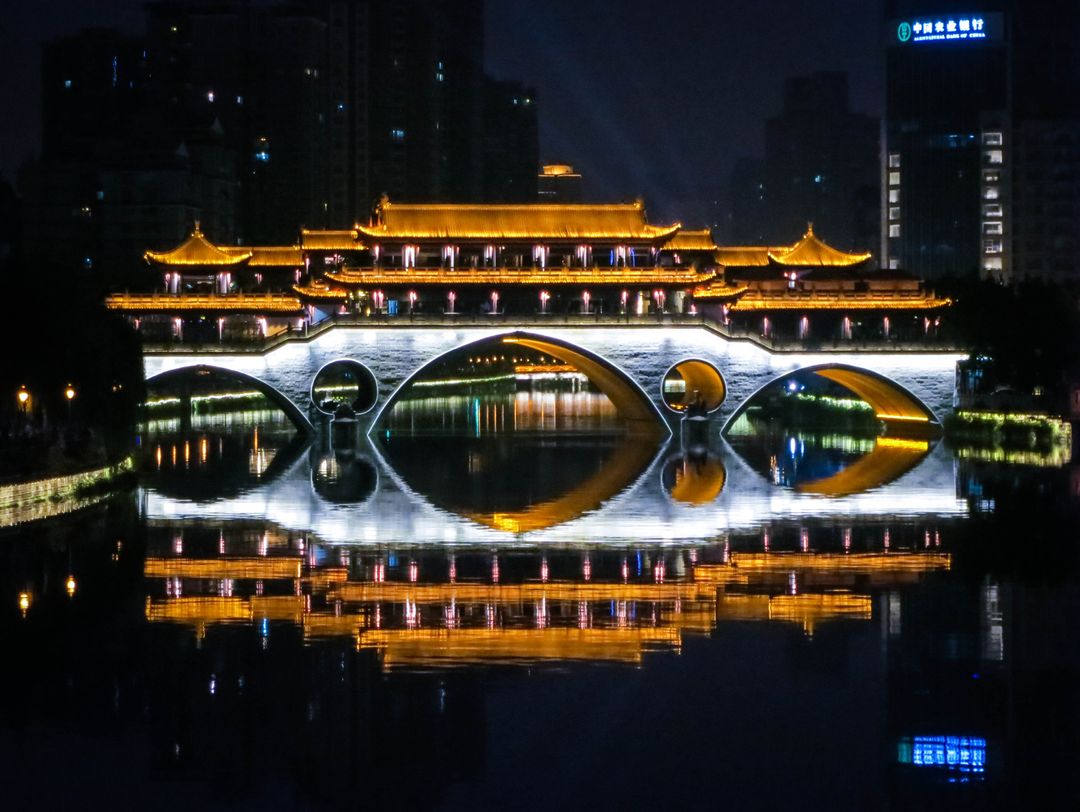 Night View of Illuminated Ancient Chinese Bridge Reflecting on River