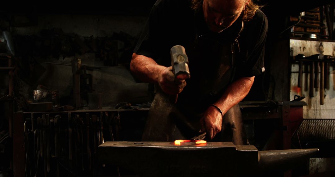 Skilled Blacksmith Working with Horseshoe in Workshop