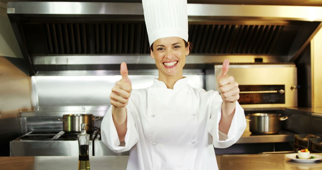 Smiling Chef Giving Thumbs Up in Professional Kitchen - Free Images, Stock Photos and Pictures on Pikwizard.com