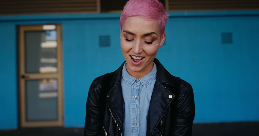 Young Woman with Vibrant Pink Hair Smiling Against Blue Background - Free Images, Stock Photos and Pictures on Pikwizard.com