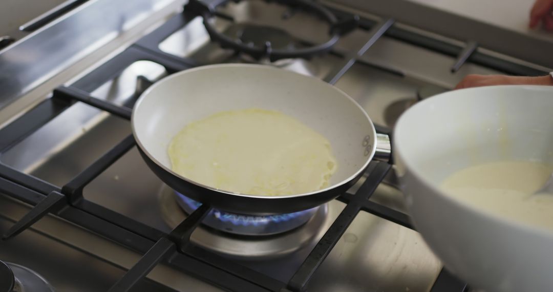 Cooking Pancake Batter on Gas Stove in Kitchen - Free Images, Stock Photos and Pictures on Pikwizard.com