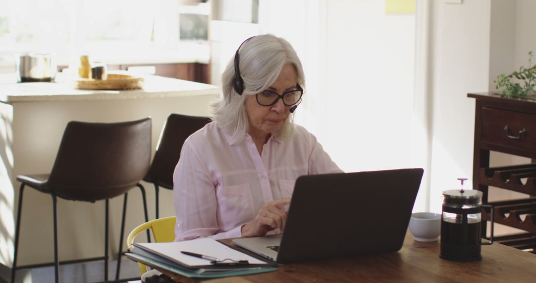 Senior Woman Working from Home on Laptop with Headphones - Free Images, Stock Photos and Pictures on Pikwizard.com