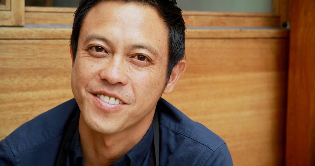 Smiling Middle-Aged Asian Man Relaxing Leisurely