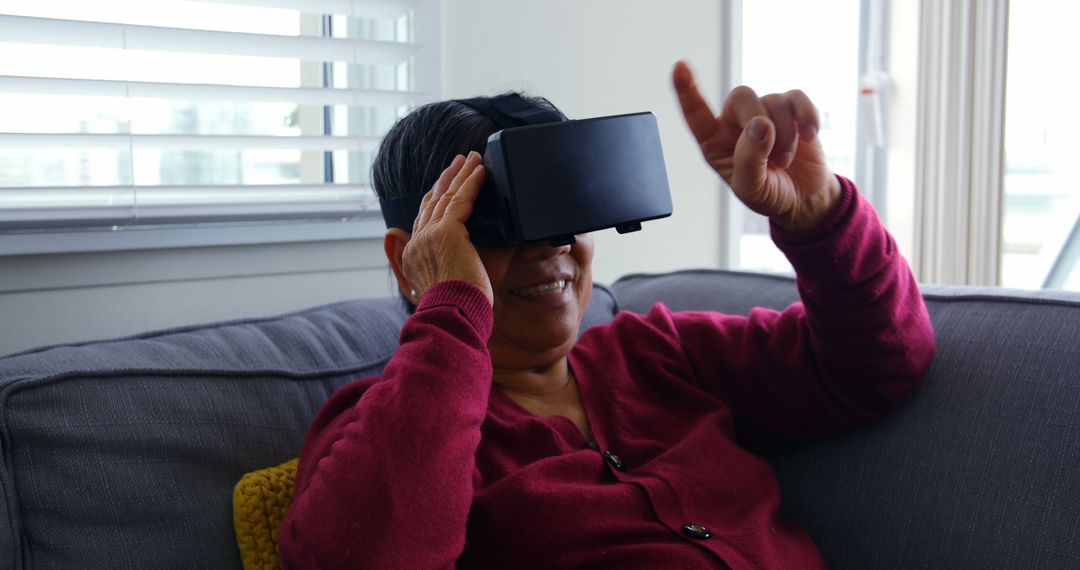 Elderly Woman Experiencing Virtual Reality at Home - Free Images, Stock Photos and Pictures on Pikwizard.com