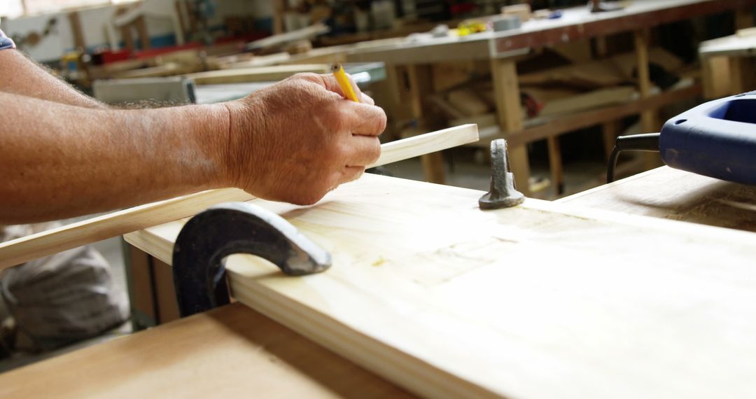 Carpenter Measuring Wood for Precise Cutting in Workshop - Free Images, Stock Photos and Pictures on Pikwizard.com