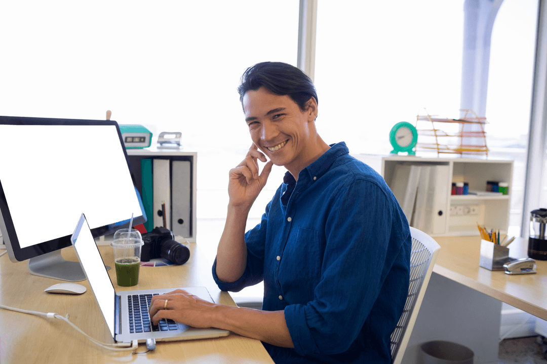 Smiling Businessman Working on Laptop with Transparent Desktop Setup