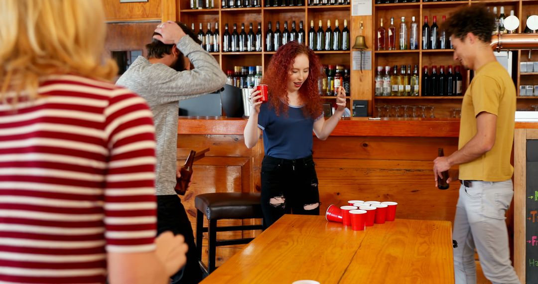 Young Students Playing Beer Pong in Bar - Free Images, Stock Photos and Pictures on Pikwizard.com