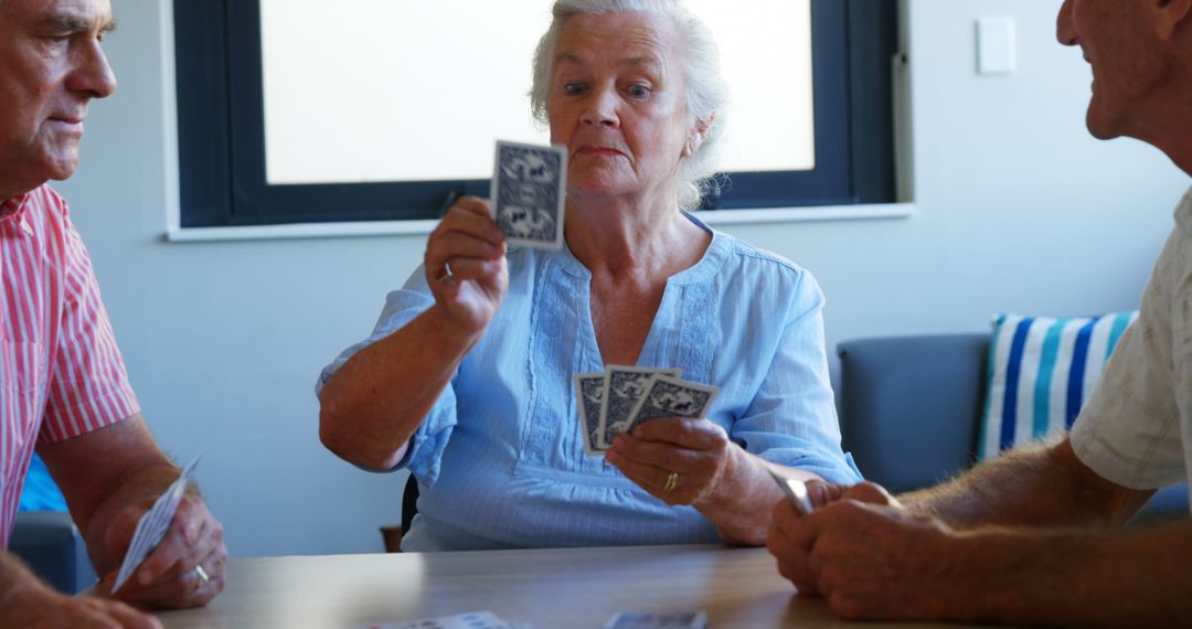 Senior Friends Enjoying Card Game Together Indoors - Free Images, Stock Photos and Pictures on Pikwizard.com