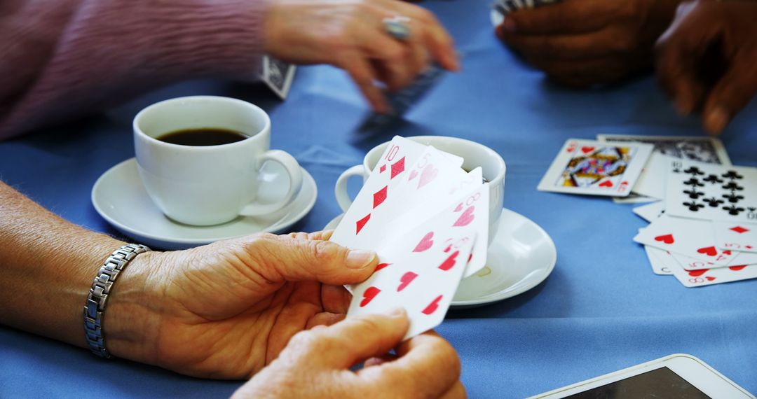 Senior Friends Enjoying Card Game with Coffee at Nursing Home