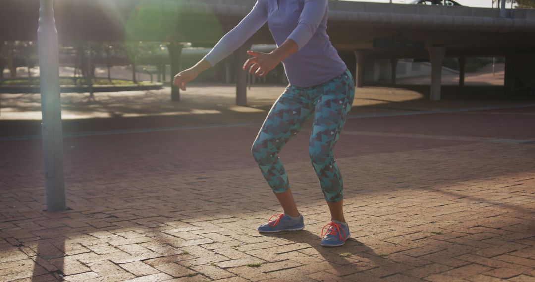 Woman Exercising Outdoors in Sunlight Performing Squats - Free Images, Stock Photos and Pictures on Pikwizard.com