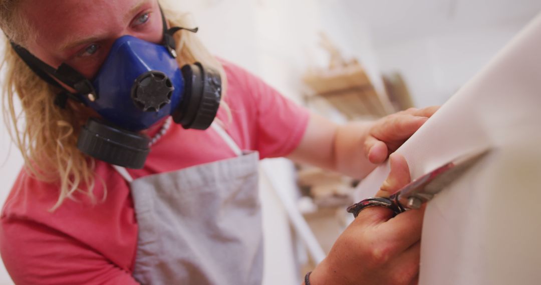 Sculptor Carving Artwork in Studio Wearing Respiratory Mask - Free Images, Stock Photos and Pictures on Pikwizard.com