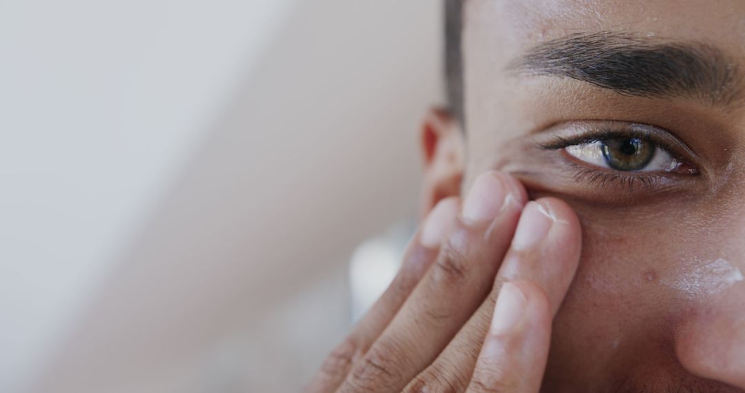 Close-Up of Man Applying Facial Moisturizer - Free Images, Stock Photos and Pictures on Pikwizard.com