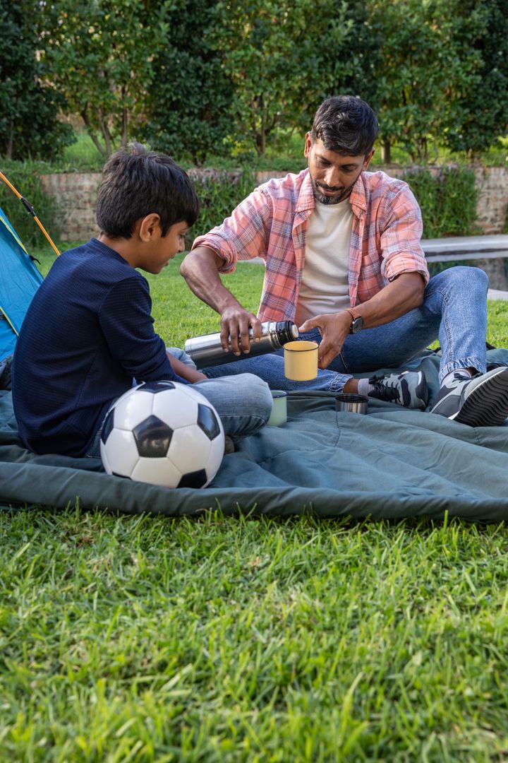 Father and Son Bonding in Backyard During Picnic Time