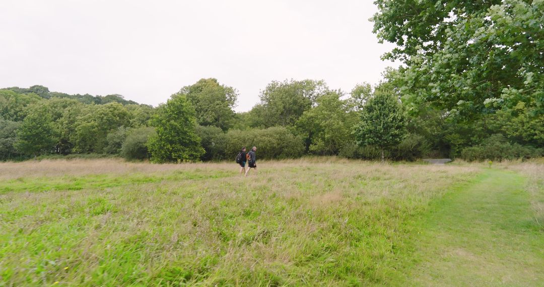 Couple Jogging Through Lush Green Field Enjoying Nature
