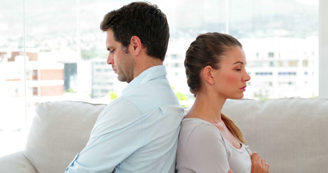 Discontent Couple Facing Away on Couch at Home