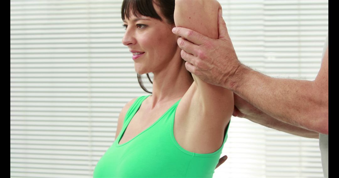 Physiotherapist Assisting Woman with Shoulder Stretch - Free Images, Stock Photos and Pictures on Pikwizard.com