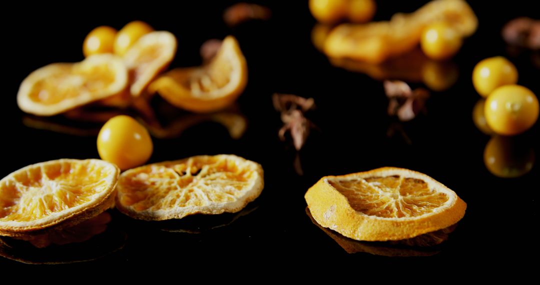 Arrangement of Dried Oranges with Additional Fruit and Spice on Black Background - Free Images, Stock Photos and Pictures on Pikwizard.com