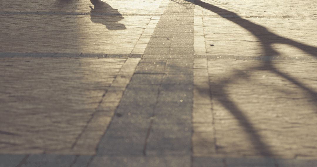 Mysterious Evening Shadows on Cobblestone Street