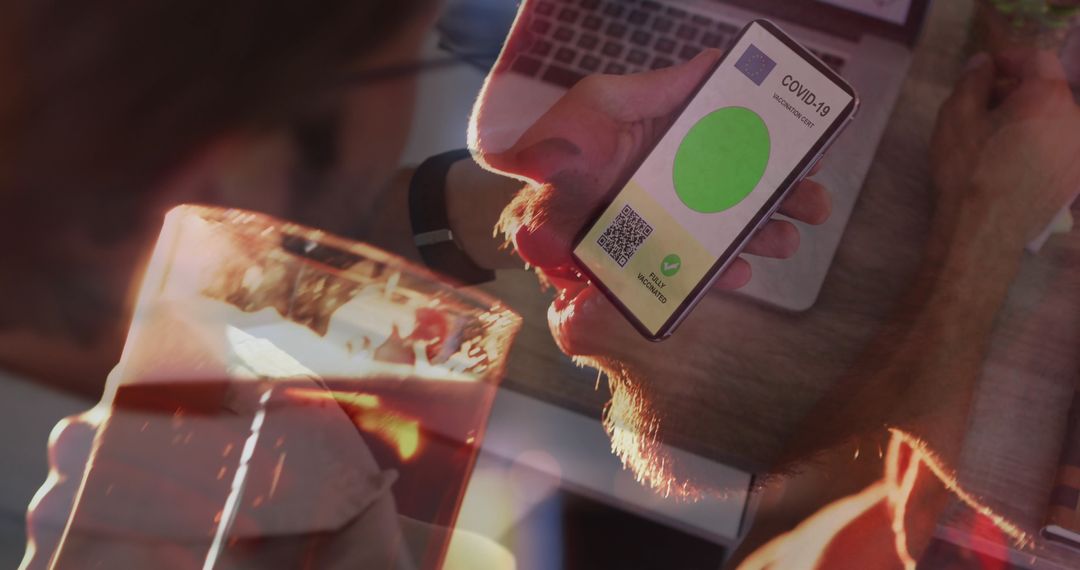 Man checks updated COVID-19 vaccination passport while enjoying beer and connecting at home