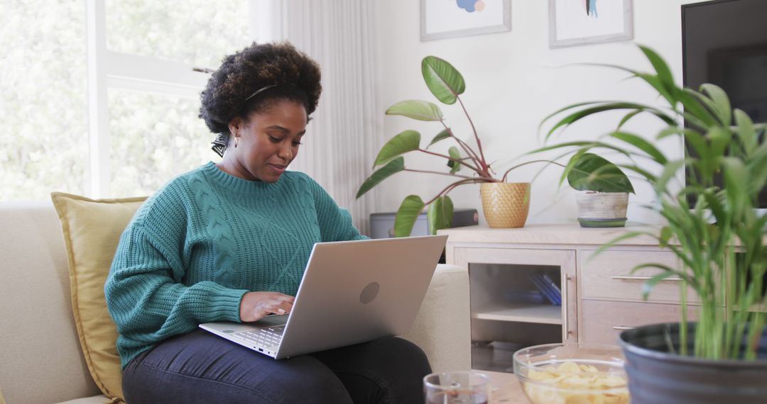 African American Woman Working from Home on Laptop in Cozy Living Room - Free Images, Stock Photos and Pictures on Pikwizard.com