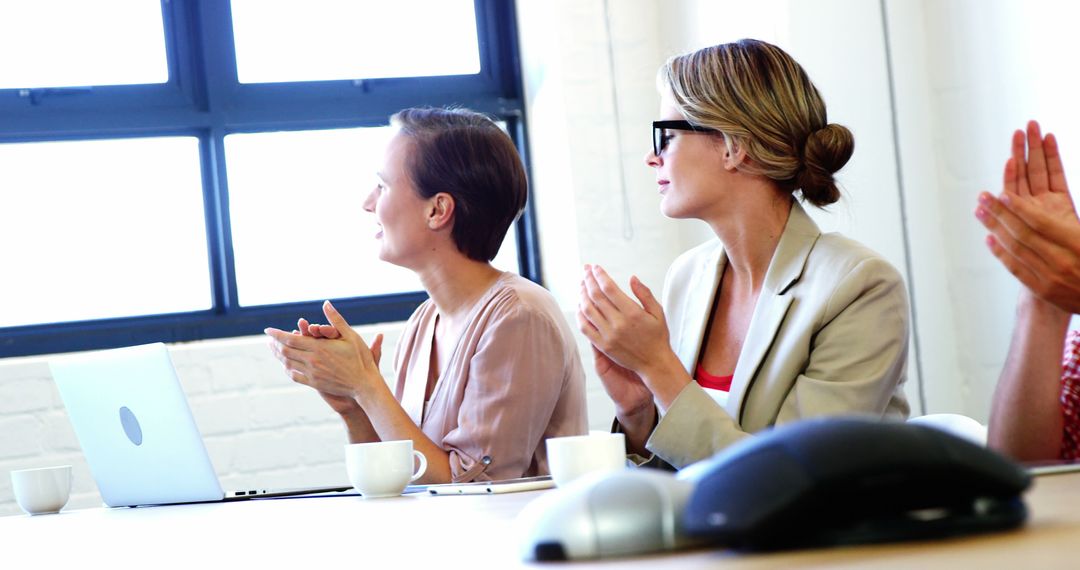 Businesswomen Applauding During Meeting in Modern Office - Free Images, Stock Photos and Pictures on Pikwizard.com