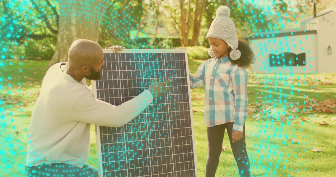 Father teaching daughter solar panel basics in backyard demonstrating renewable energy for kids