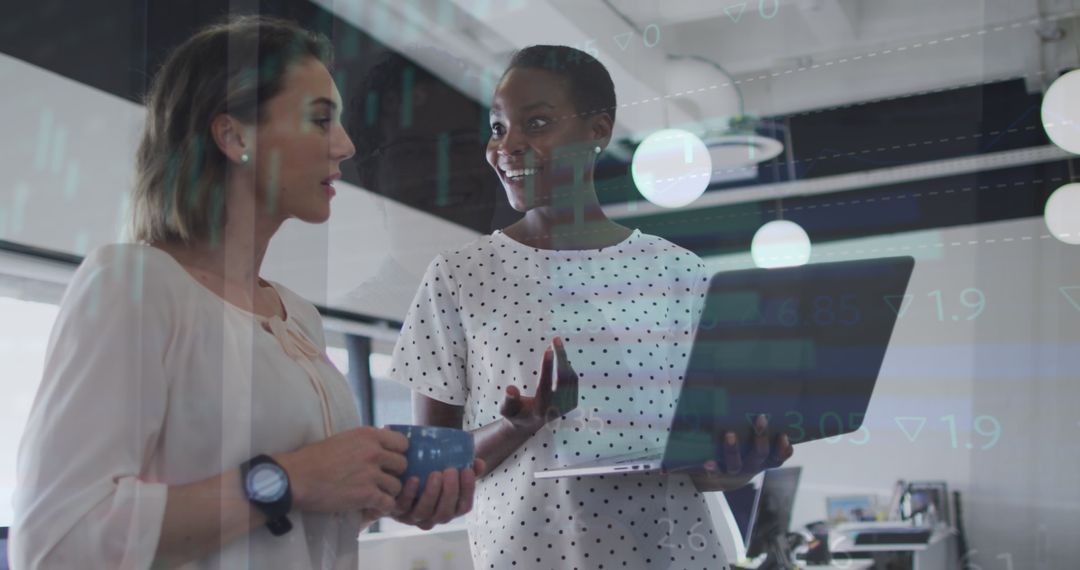 Female Colleagues Discuss Business with Digital Interface in Office