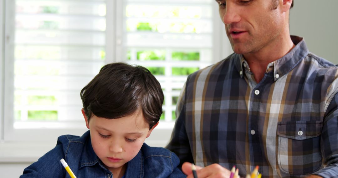 Father Helping Young Son with Homework - Free Images, Stock Photos and Pictures on Pikwizard.com