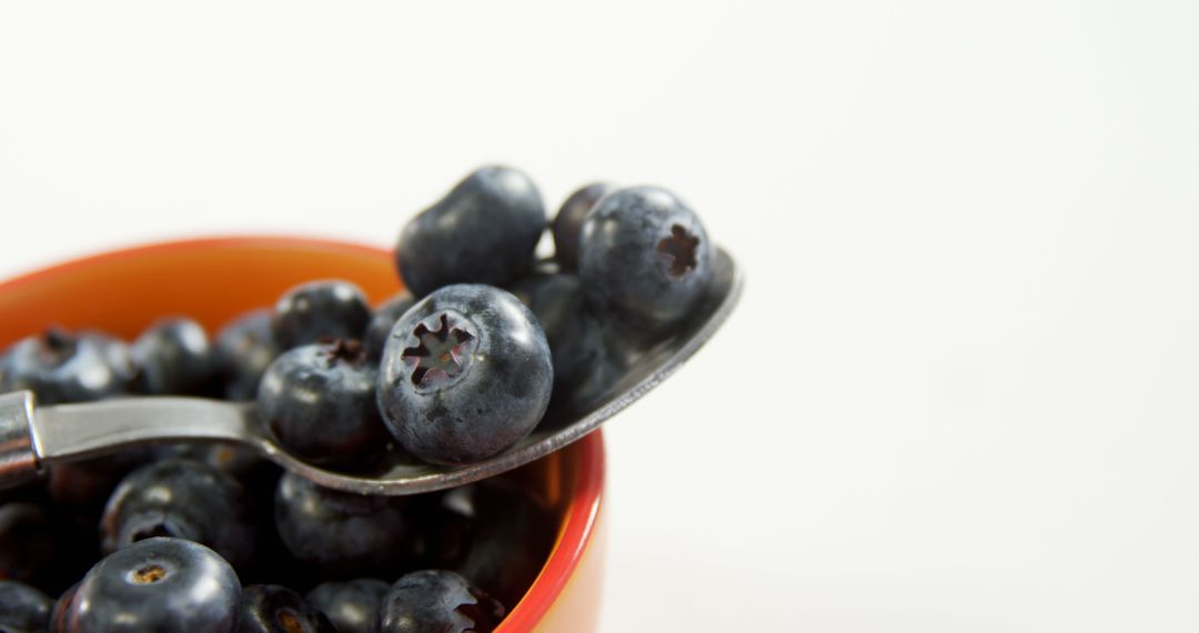 Close-Up of Fresh Blueberries in Bowl with Spoon - Free Images, Stock Photos and Pictures on Pikwizard.com