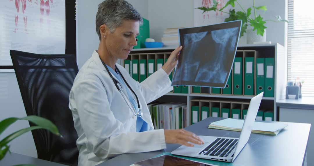 Female Doctor Analyzing X-Ray on Laptop in Medical Office - Free Images, Stock Photos and Pictures on Pikwizard.com