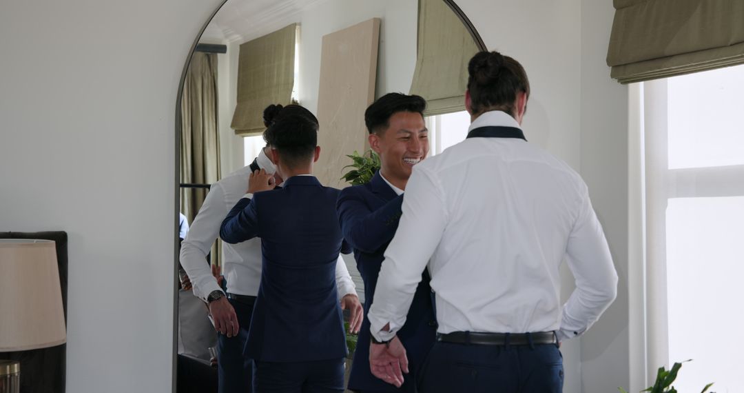 Groom and Best Man Preparing for Wedding in Front of Mirror