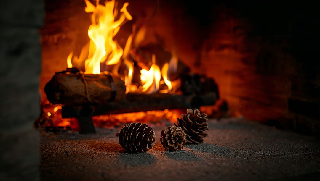 Glowing Pine Cones Resting on Stone Hearth Beside Rustic Fireplace Ember Glow