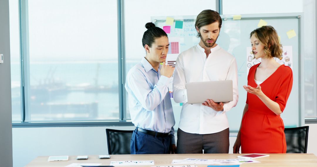 Diverse Professionals Collaborating on Laptop Workstation