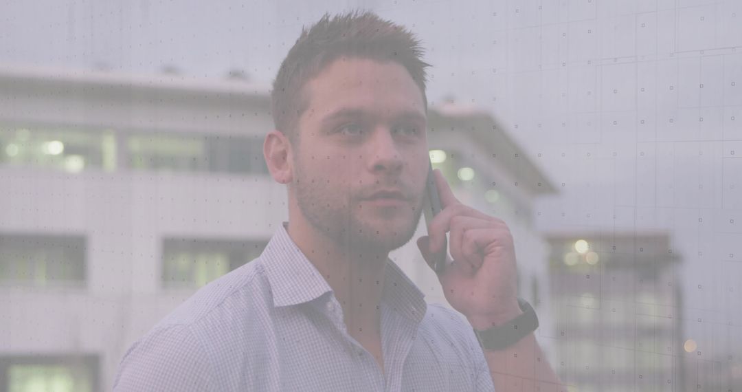 Businessman on Smartphone in Front of City Office Building at Dusk