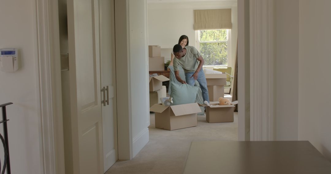 Couple Unpacking Boxes in New Home with Joyful Anticipation
