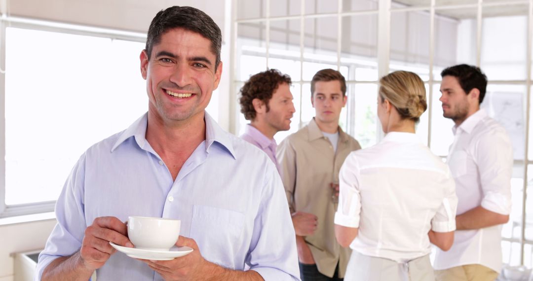 Smiling Man Holding Coffee Cup During Office Break - Free Images, Stock Photos and Pictures on Pikwizard.com