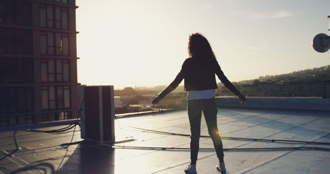 Woman Standing on Rooftop Admiring Sunset - Free Images, Stock Photos and Pictures on Pikwizard.com