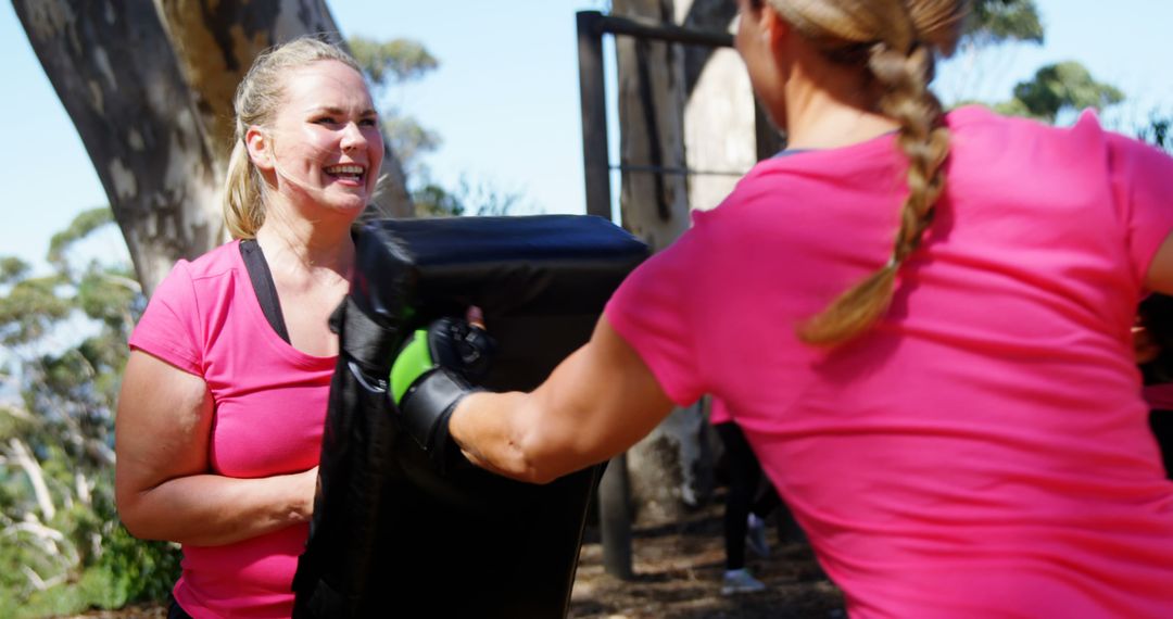 Women Practicing Self-Defense Exercises Outdoors in Pink Shirts - Free Images, Stock Photos and Pictures on Pikwizard.com