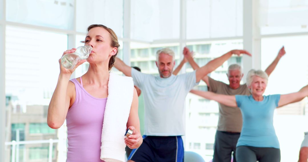 Group of seniors exercising and staying hydrated in modern fitness studio - Free Images, Stock Photos and Pictures on Pikwizard.com