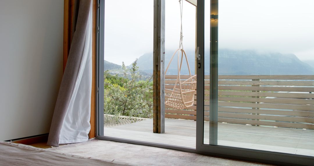 Serene Deck with Rattan Swing and Misty Mountain View