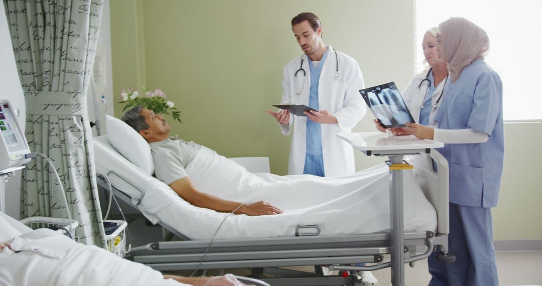 Medical Team Discussing Patient's Condition by Bedside - Free Images, Stock Photos and Pictures on Pikwizard.com