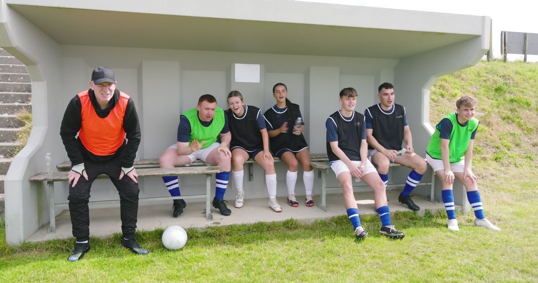 Soccer Team Substitutes Watching Match in Dugout Shelter
