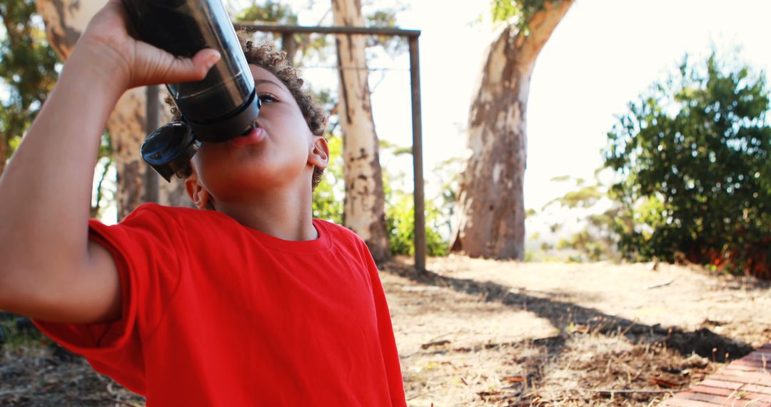 Young Boy Drinking Water Outdoors in Nature - Free Images, Stock Photos and Pictures on Pikwizard.com