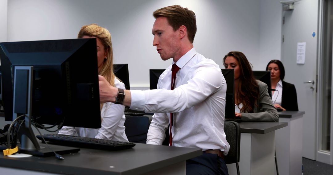 Focused Business Professionals Working on Computers in Office